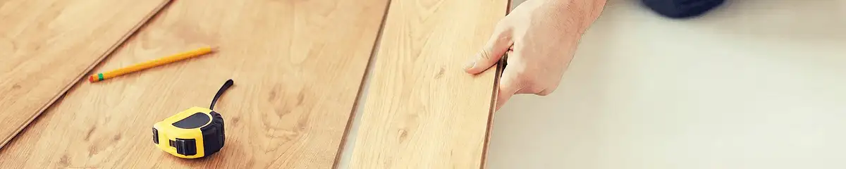 A professional installing wood flooring in Chandler, AZ